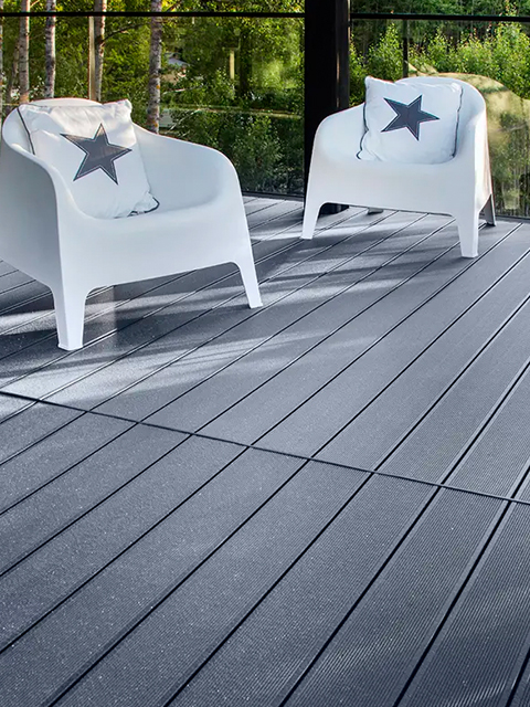 Worker applying deck coating with roller